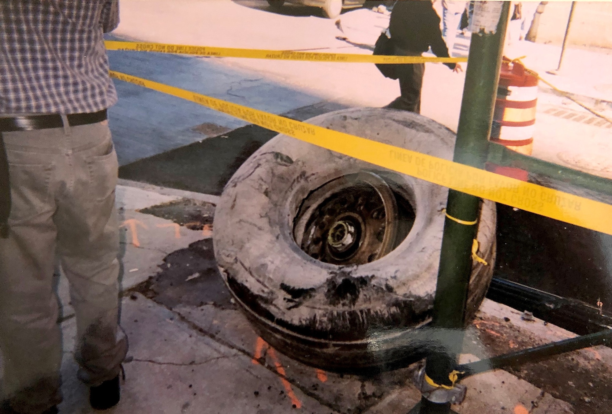 A tire from one of the aircraft that flew into one of the Twin Towers is cordoned off Sept. 11, 2001, in the street in front of the World Trade Center, New York City, New York. Col. Ephod Shang, vice commander of the 367th Recruiting Group and deputy director at the Air Force Reserve Command headquarters for Recruiting on Robins AFB, Georgia, ran towards the Twin Towers after seeing the smoke from the first crash to help people and photograph the events around him which he saw as a priority from his experience as a Reserve Citizen Airman intelligence officer. (Courtesy photo by Col. Ephod Shang)