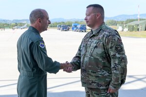 U.S. Air Force Gen. Jeff L. Harrigian, U.S. Air Forces in Europe and Air Forces Africa commander, coins U.S. Air Force Master Sgt. Corey March, 555th Aircraft Maintenance Unit production superintendent, during exercise Agile Wyvern at Cerklje ob Krki Air Base, Slovenia, Sept. 9, 2021. While visiting, Harrigian received an Agile Combat Employment tour, conducted a coin recognition ceremony and toured the base. (U.S. Air Force photo by Senior Airman Brooke Moeder)
