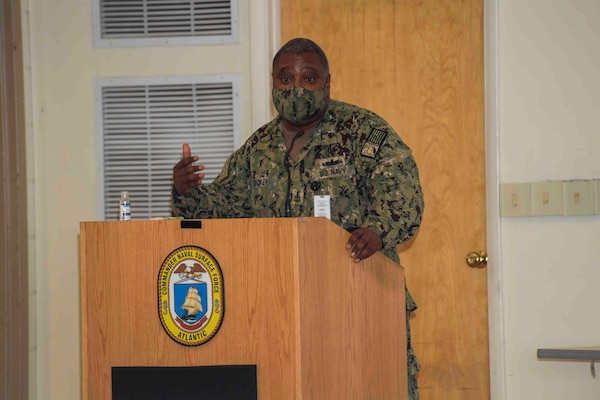 NAVAL STATION NORFOLK (Sept. 9, 2021) Senior Chief Intelligence Specialist Wesley Dickey speaks during a 9/11 20th anniversary remembrance ceremony, Sept. 9. The ceremony honored those affected by the deadliest series of terrorist attacks since Pearl Harbor, affirming the United States Navy’s ongoing commitment to deter future terrorist attacks and to never forget our American legacy of tenacity and resiliency.  (U.S. Navy photo by Mass Communication Specialist 1st Class Jacob Milham) (This photo has been altered for security purposes by blurring out identification badges.)