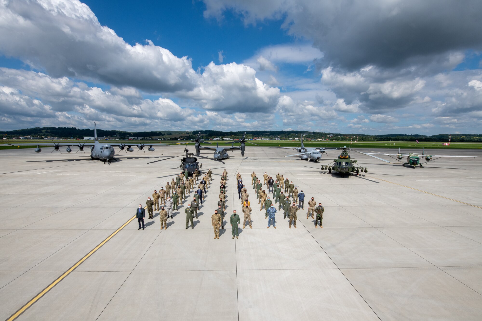 Multinational air force delegates gather for a class photo and static display at the European Partnership Flight event during the Building Partner Aviation Capacity Seminar in Krakow, Poland, Sept. 2, 2021.