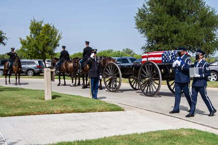 Air Force Honor Guard members carry the remains of retired Col. Richard E. Cole and the U.S. flag during his interment, Sept. 7, 2021.