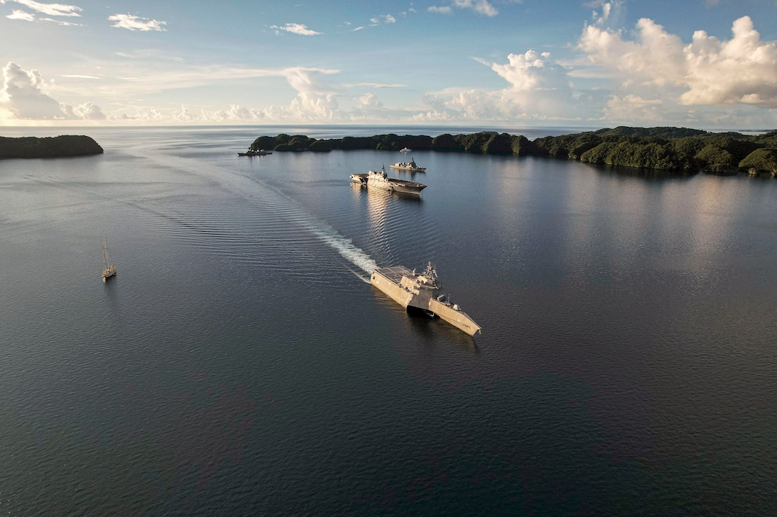 Several ships sail in calm waters.