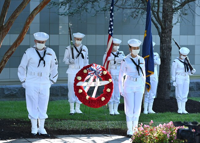 SUITLAND, Md. (September 10, 2021) The Office of Naval Intelligence (ONI) honor guard flanks a memorial wreath during the 9/11 20th anniversary ceremony at the National Maritime Intelligence Center. Eight ONI shipmates serving in the Chief of Naval Operations Intelligence Plot in the Pentagon perished during the terrorist attacks that day: Cmdr. Dan Shanower, Lt. Cmdr Vince Tolbert, Lt. Jonas Panik, Lt. Darin Pontell, Petty Officer 1st Class Julian Cooper, Angela Houtz, Brady Howell, and Gerard Moran.