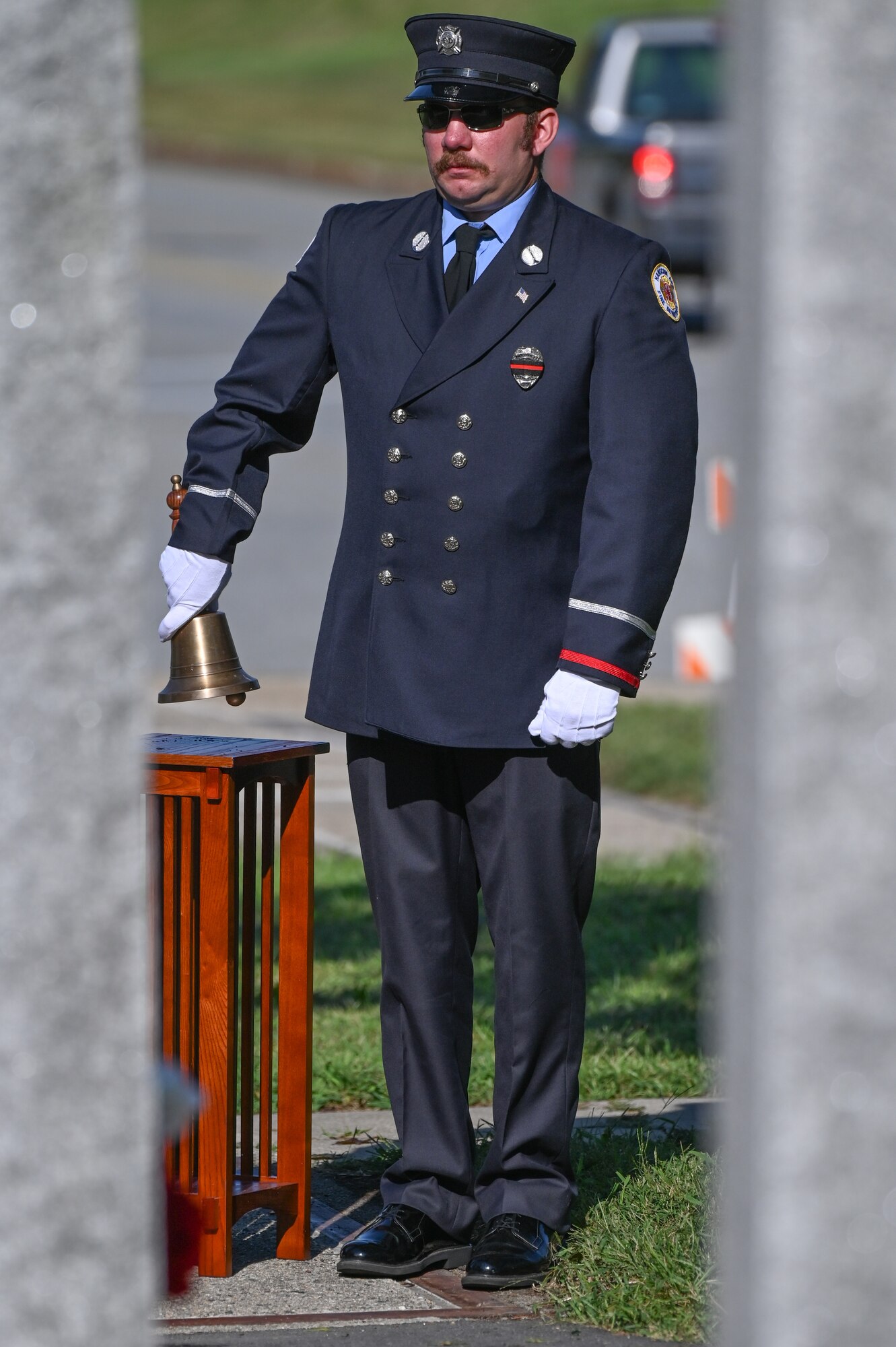 Hanscom Fire Lt. Steven Koberski rings a bell during a 9/11 remembrance ceremony