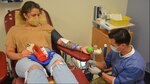 Petty Officer 3rd Class Shailynn Galvin, of Navy Information Operations Command (NIOC) Georgia, relaxes while donating blood Tuesday at Kendrick Memorial Blood Center. Galvin was one of more than 150 Navy personnel who donated to the Armed Services Blood Program during a blood drive organized by NIOC-Georgia. Assisting Galvin is Staff Sgt. Jesse Elwood, a medic assigned to KMBC. (Laura Levering / Fort Gordon Public Affairs)