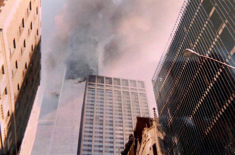 Smoke and flames come from the Twin Towers Sept. 11, 2001, at the World Trade Center, New York City, New York. This photo was captured with a disposable camera purchased specifically to capture events as they unfolded in front of Col. Ephod Shang, vice commander of the 367th Recruiting Group and deputy director at the AFRC Headquarters for Recruiting on Robins AFB, Georgia, when he was a newly minted captain at the time.