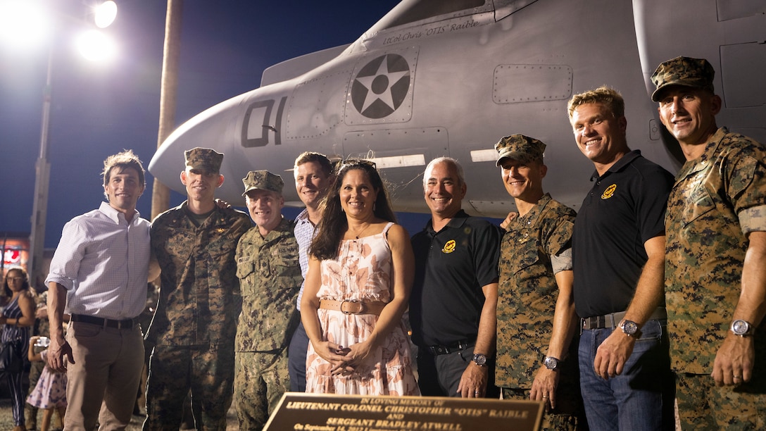 U.S. Marines, veterans and families pose in front an AV-8B Harrier during a dedication ceremony at the open air museum on Marine Corps Air Station Yuma, Ariz., Aug. 19, 2021. Marines from 3rd Marine Aircraft Wing and across the Marine Corps participated in a ceremony unveiling and dedicating an AV-8B Harrier at the museum to the late Lt. Col. Christopher “Otis” Raible and Sgt. Bradley Atwell, whom gave their lives defending the aircraft as well as surrounding Marines during an attack on Camp Bastion, Afghanistan in 2012.