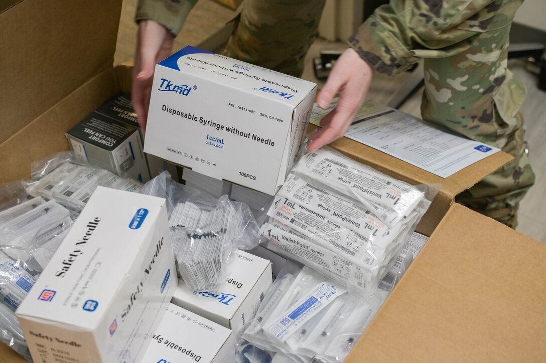 U.S. Air Force Staff Sgt. Casey Rowe, 23rd Health Care Operations Squadron allergy and immunizations technician, sorts through a box of vaccine supplies at Moody Air Force Base, Georgia, Sept. 9, 2021. The 23rd HCOS will begin administering the Pfizer vaccine on Sept. 17, 2021 to active duty personnel only and begin on Sept. 20, 2021 to the Moody community. (U.S. Air Force photo by Senior Airman Rebeckah Medeiros)