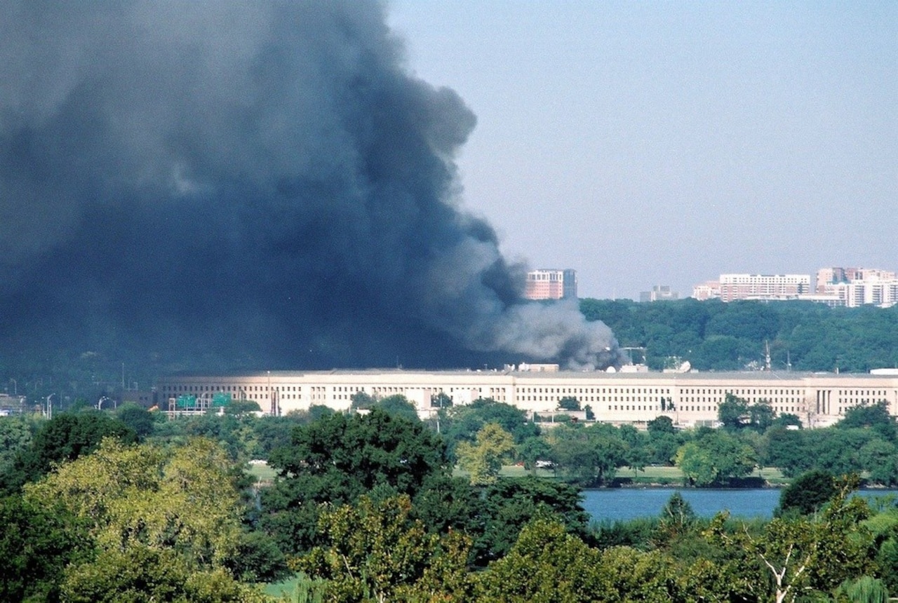 Smoke plumes rise from a building.