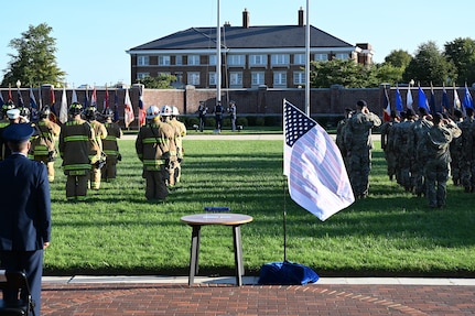 Attendees observe and salute as members of The United States Air Force Honor Guard raise the American flag during a 9/11 memorial ceremony at Joint Base Anacostia- Bolling, Washington D.C. on Sept. 10, 2021. Mission partners from across the National Capitol Region gathered at JB Anacostia-Bolling to honor those who died 20 years ago during the terror attacks on the World Trade Center and the Pentagon on September 11, 2001. (U.S. Air Force photo by Staff Sgt. Kayla White)