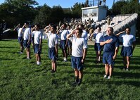 Airmen salute during a 9/11 memorial ceremony at Joint Base Anacostia-Bolling, Washington D.C. on Sept. 10, 2021. The Airmen ran across the base and along the Potomac River waterfront while carrying a specially-designed baton and flag to kick off a 24-hour memorial run and walk event. Mission partners from across the National Capitol Region gathered at JB Anacostia-Bolling to honor those who died 20 years ago during the terror attacks on the World Trade Center and the Pentagon on September 11, 2001. (U.S. Air Force photo by Staff Sgt. Kayla White)