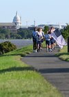 U.S. Air Force Staff. Sgt. Bryan Potter, 794th Communication Squadron, and 1st Lt. Hillary Bissing, 11th Logistics Readiness Squadron, carry a ceremonial baton and flag during a 9/11 memorial run along the Potomac River at Joint Base Anacostia-Bolling, Washington D.C. on Sept. 10, 2021. Mission partners from across the National Capitol Region gathered at JB Anacostia-Bolling to honor those who died 20 years ago during the terror attacks on the World Trade Center and the Pentagon on September 11, 2001. (U.S. Air Force photo by Staff Sgt. Kayla White)