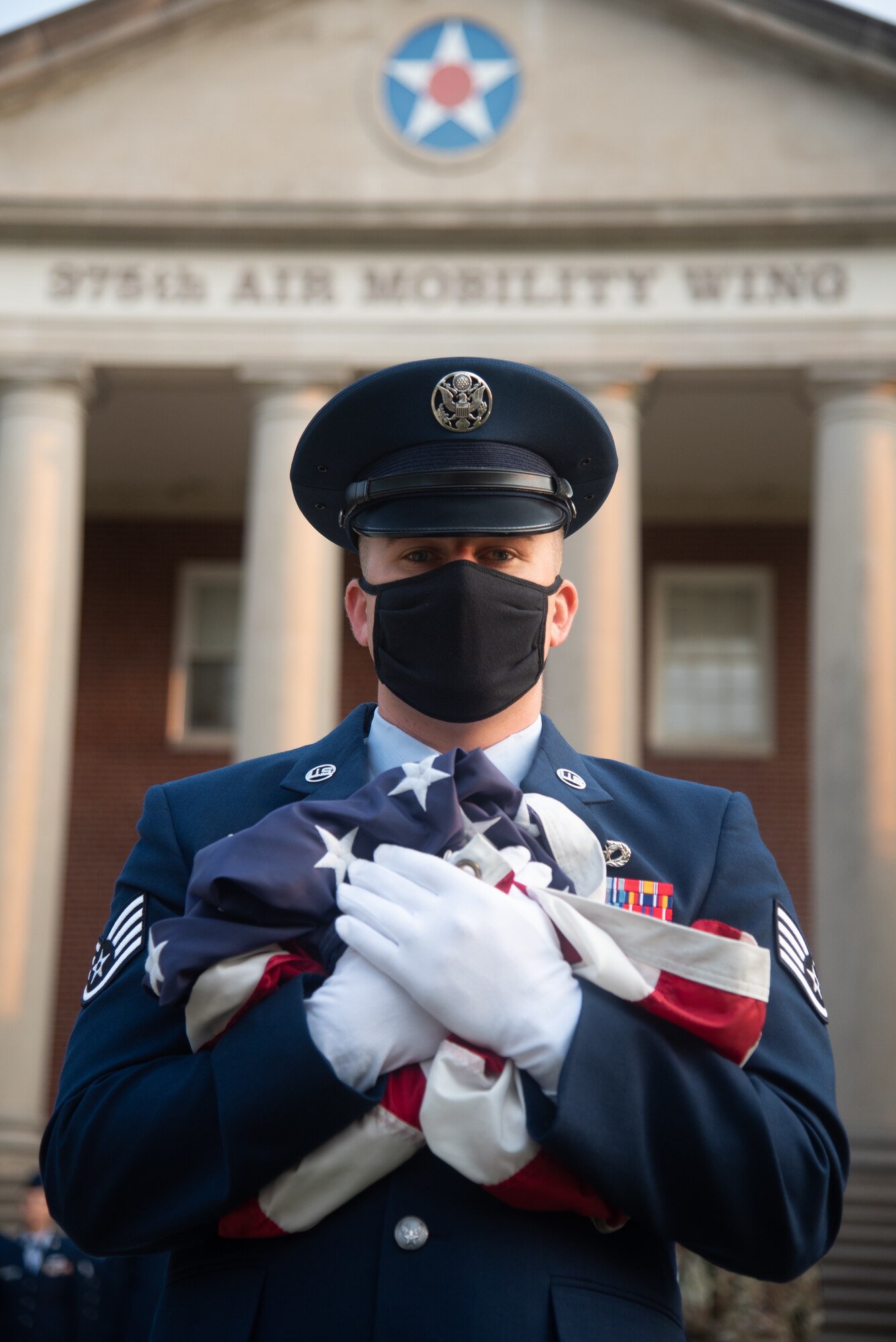 U.S. Air Force Staff Sgt. Daniel Merritt, 375th Civil Engineer Squadron crew chief, holds the U.S. flag before the 9/11 remembrance ceremony begins on Scott Air Force Base, Illinois, September 10, 2021. The ceremony was held to remember the lives lost in the terrorist attacks on September 11, 2001. (U.S. Air Force photo by Airman 1st Class Stephanie Henry)