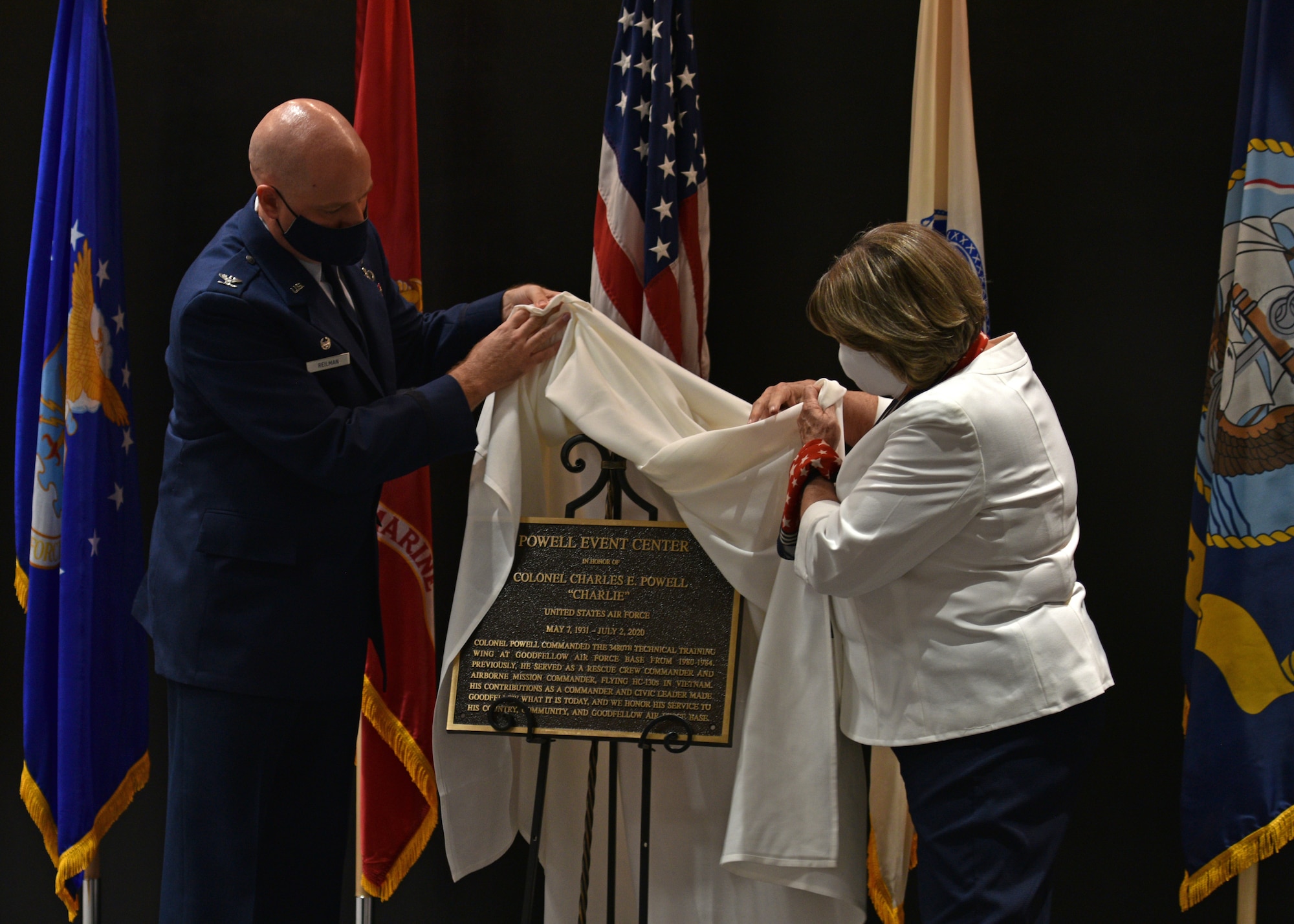 U.S. Air Force Col. Matthew Reilman, 17th Training Wing commander, and Theresa Ann McKinney, daughter of U.S. Air Force Retired Col. Charles E. Powell and JoAnne Powell, unveil the dedication plaque during the Powell Event Center dedication ceremony on Goodfellow Air Force Base, Sept. 10, 2021. Theresa and several family members were in attendance to remember and honor the legacy of Charles and JoAnne Powell. (U.S. Air Force photo by Senior Airman Ashley Thrash)