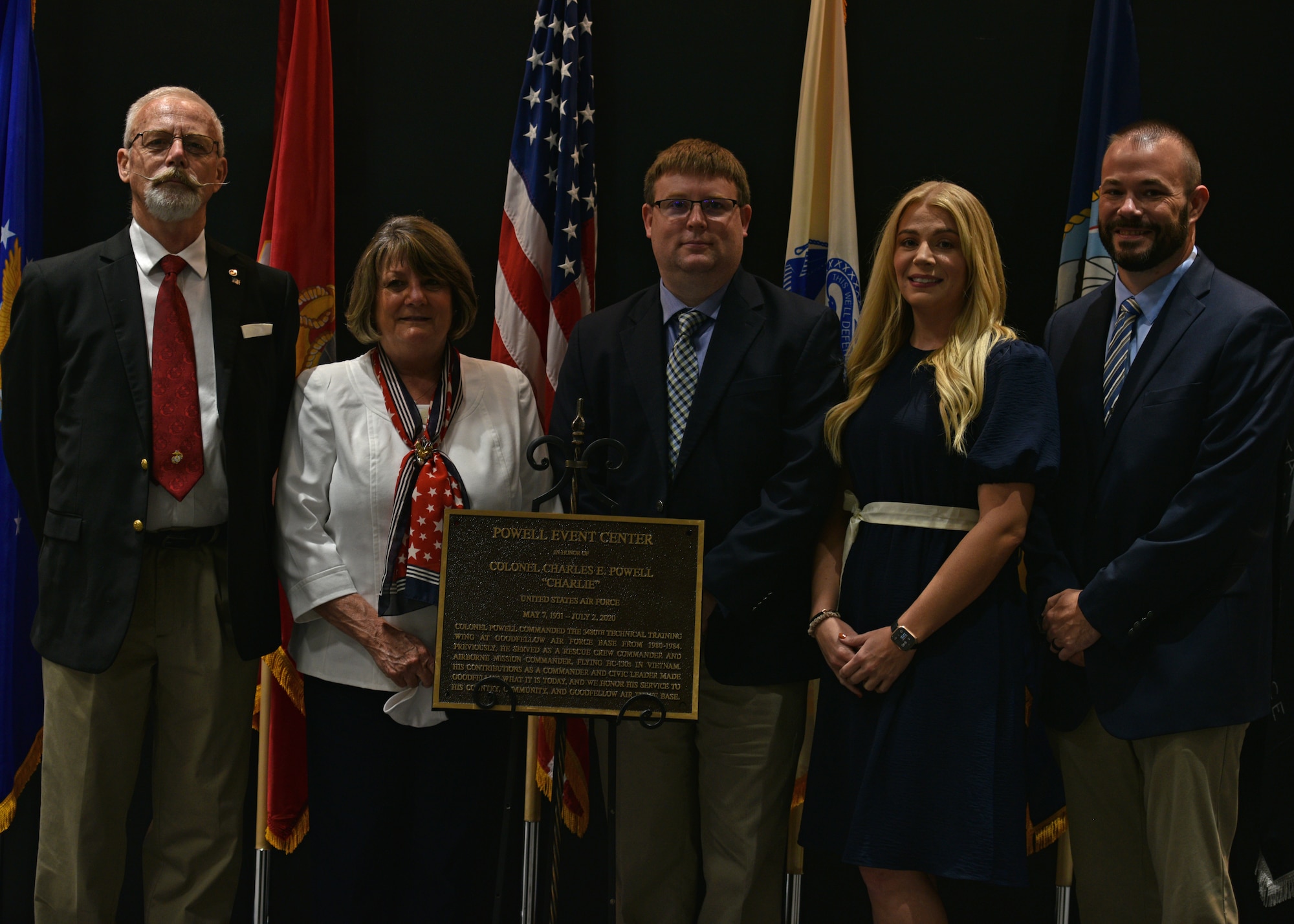 Family members of U.S. Air Force Retired Col. Charles E. Powell and JoAnne Powell, stand with the dedication plaque during the Powell Event Center dedication ceremony on Goodfellow Air Force Base, Sept. 10, 2021. Charles Powell was the commander of the 3480th Technical Training Wing at Goodfellow AFB from 1980-1984. (U.S. Air Force photo by Senior Airman Ashley Thrash)