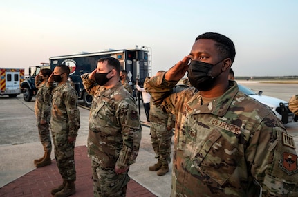 Members of the 502nd Air Base Wing salute as the U.S. flag is lowered to half-staff at Joint Base San Antonio-Lackland Sept. 10 in honor of those lost in the terrorist attacks of Sept. 11, 2001.