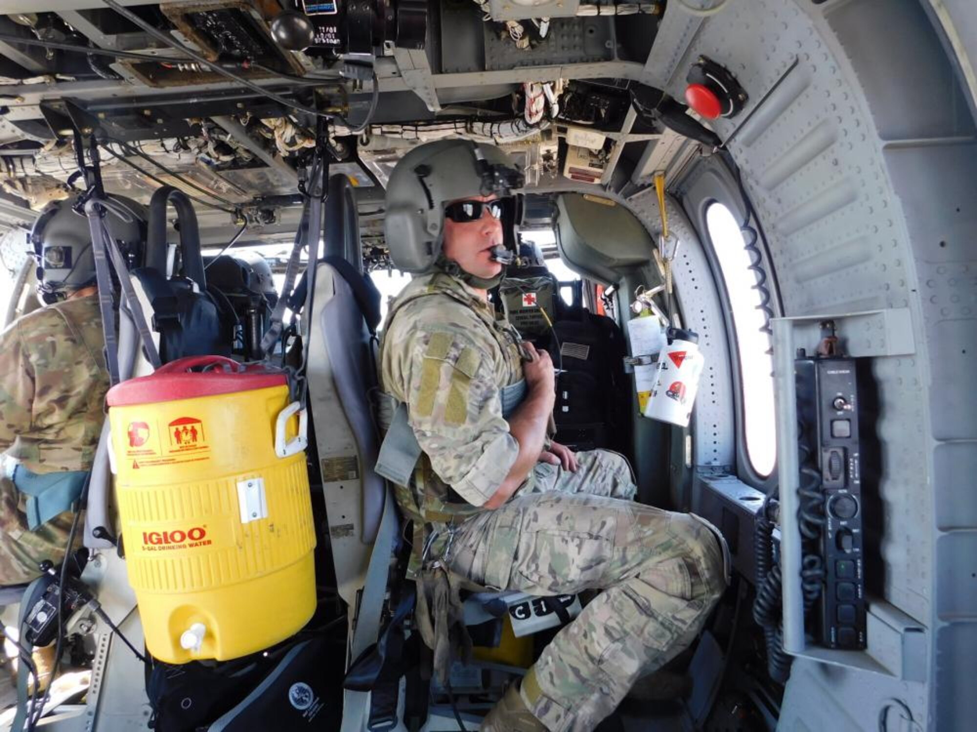 Air Force aircrew member aboard HH-60G Pave Hawk helicopter.