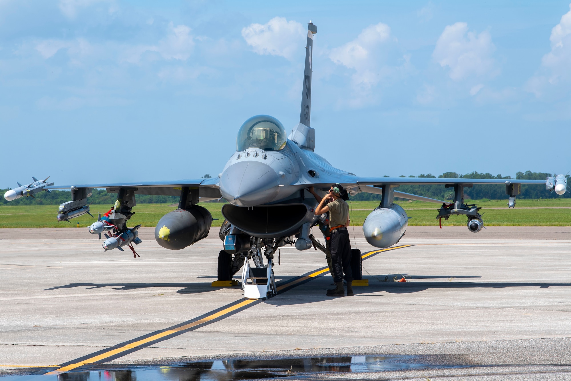 A maintainer with the 79th Fighter Squadron (FS), Shaw Air Force Base, South Carolina, performs a preflight check on an F-16 Fighting Falcon aircraft at MacDill Air Force Base, Florida, Sept. 8, 2021.