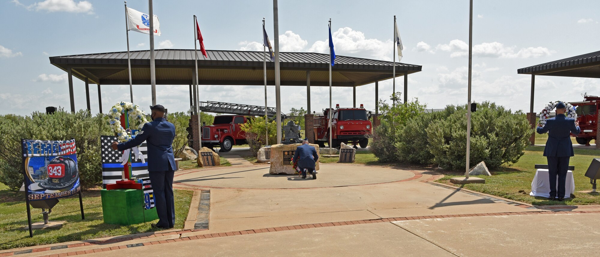 U.S. Air Force members assigned to the 17th Training Wing display wreaths to honor the firefighters who fell in the line of duty, during a 9/11 memorial ceremony at the Firefighter Memorial Troop Walk, on Goodfellow Air Force Base, Texas, Sept. 8, 2021. The ceremony included a moment of silence, a wreath laying and words spoken in remembrance of the fallen firefighters. (U.S. Air Force by Senior Airman Abbey Rieves)
