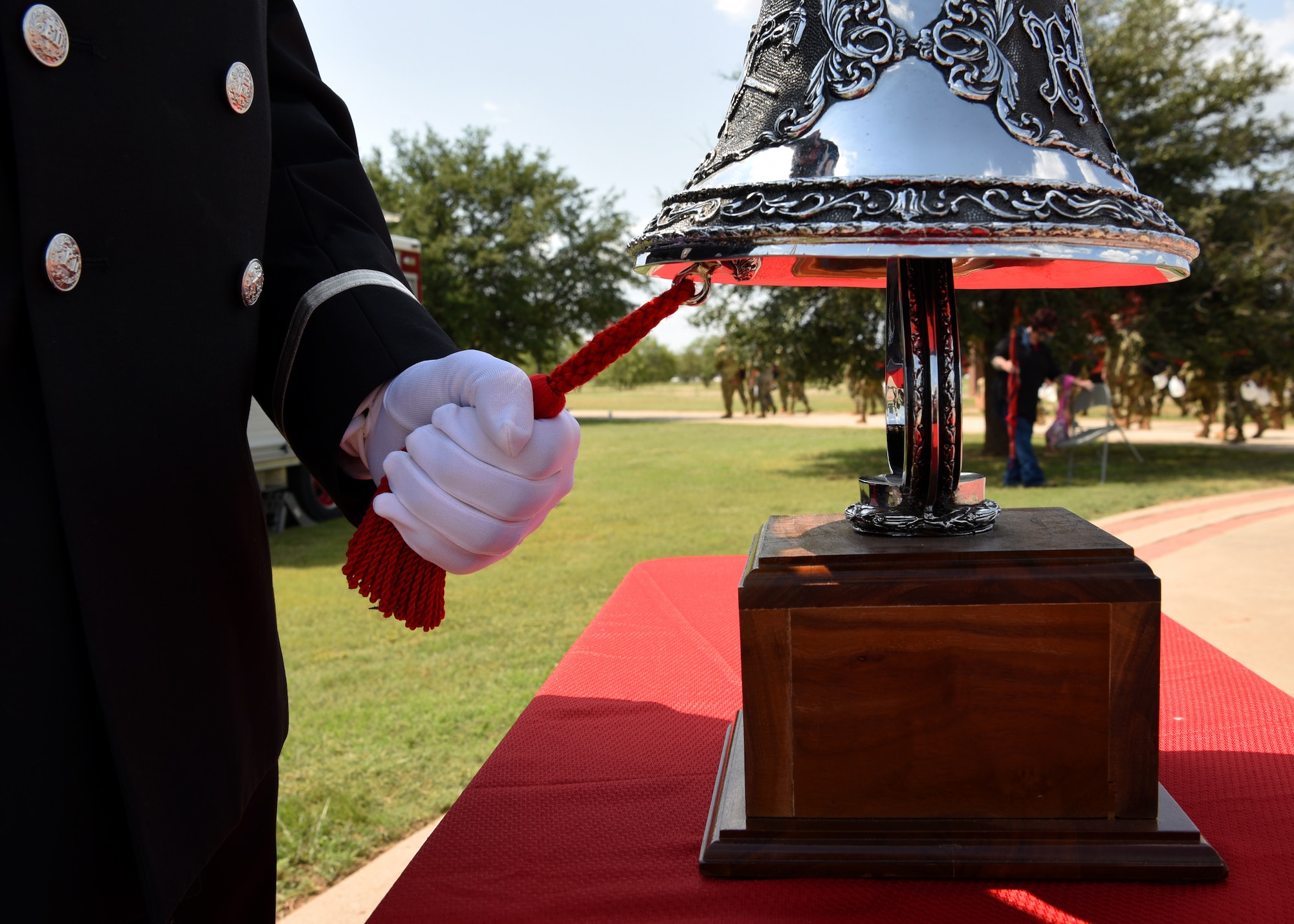 Lance Sauceda, City of San Angelo firefighter and paramedic, rings the fireman’s bell five times in honor of every firefighter that has fallen in the line of at a 9/11 memorial ceremony at the Firefighter Memorial Troop Walk, on Goodfellow Air Force Base, Texas, Sept. 8, 2021. The 312th Training Squadron holds a memorial every year to recognize the firefighters, and adds new names to the memorial as needed. (U.S. Air Force photo by Senior Airman Abbey Rieves)