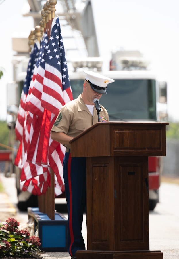 Master Gunnery Sgt. Pasquale Foresta with 6th Communication Battalion, Force Headquarters Group, Marine Forces Reserve, addresses guests during a 9/11 remembrance ceremony at the Curtin Garvey Complex, Brooklyn, New York, Aug. 14, 2021. Foresta served with Sgt. Maj. Michael S. Curtin and Gunnery Sgt. Mathew D. Garvey, Reserve Marines with 6th Communication Battalion, who made the ultimate sacrifice as first responders on September 11, 2001. Curtin, a police officer with the New York City Police Department, and Garvey, a firefighter with the New York City Fire Department, epitomized what it means to be a Reserve Marine, answering the nation's call to serve in uniform while also serving their local communities. (U.S. Marine Corps Photo By Lance Cpl. Ashley Corbo)