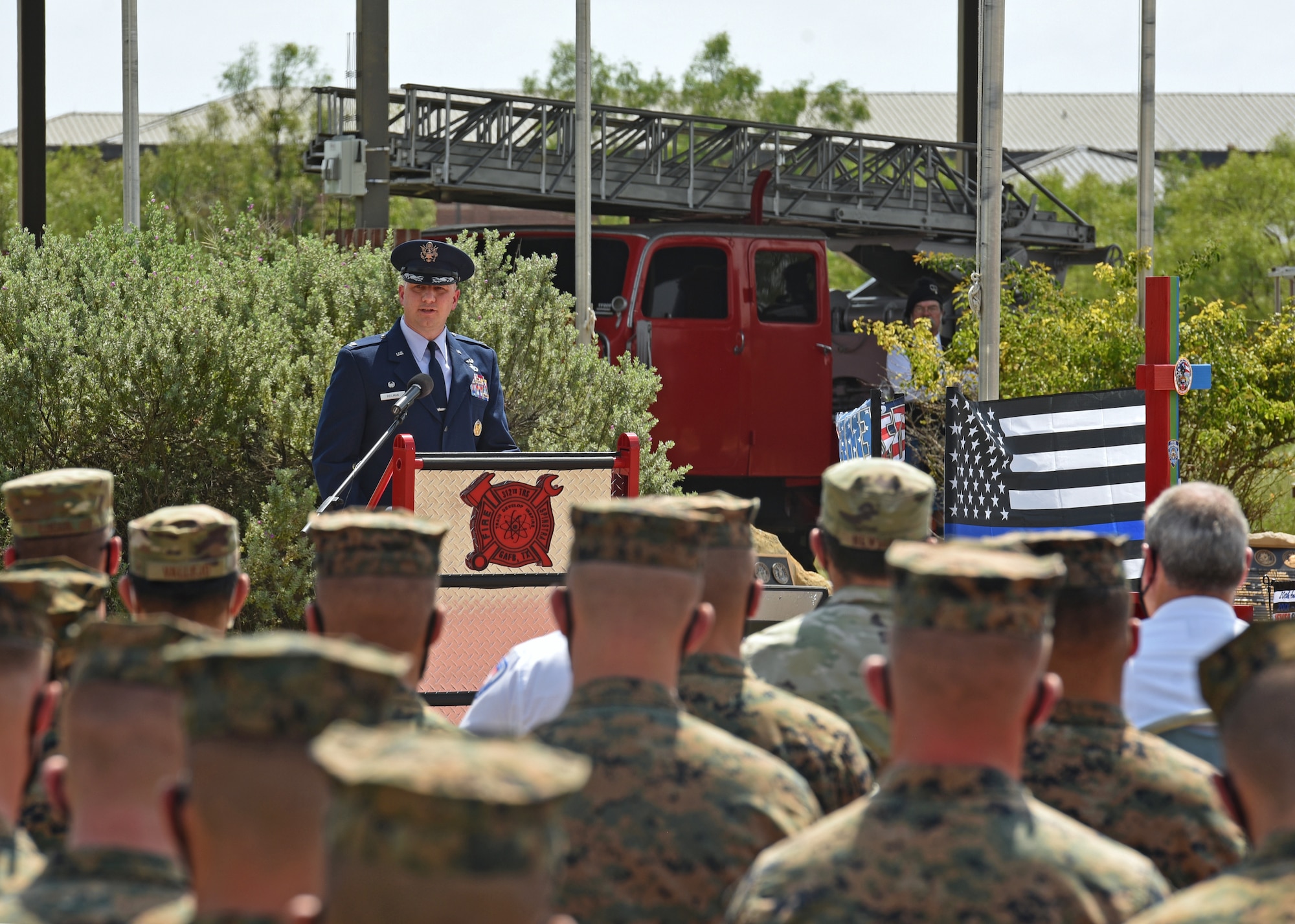 U.S. Air Force Col. Matthew Reilman, 17th Training Wing commander, speaks his opening remarks at the 20th Anniversary Commemoration Ceremony, at the Firefighter Memorial Troop Walk, on Goodfellow Air Force Base, Texas, Sept. 8, 2021. Reilman reminded atendees the importance of remembering our fallen brothers and sisters. (U.S. Air Force photo by Senior Airman Abbey Rieves)