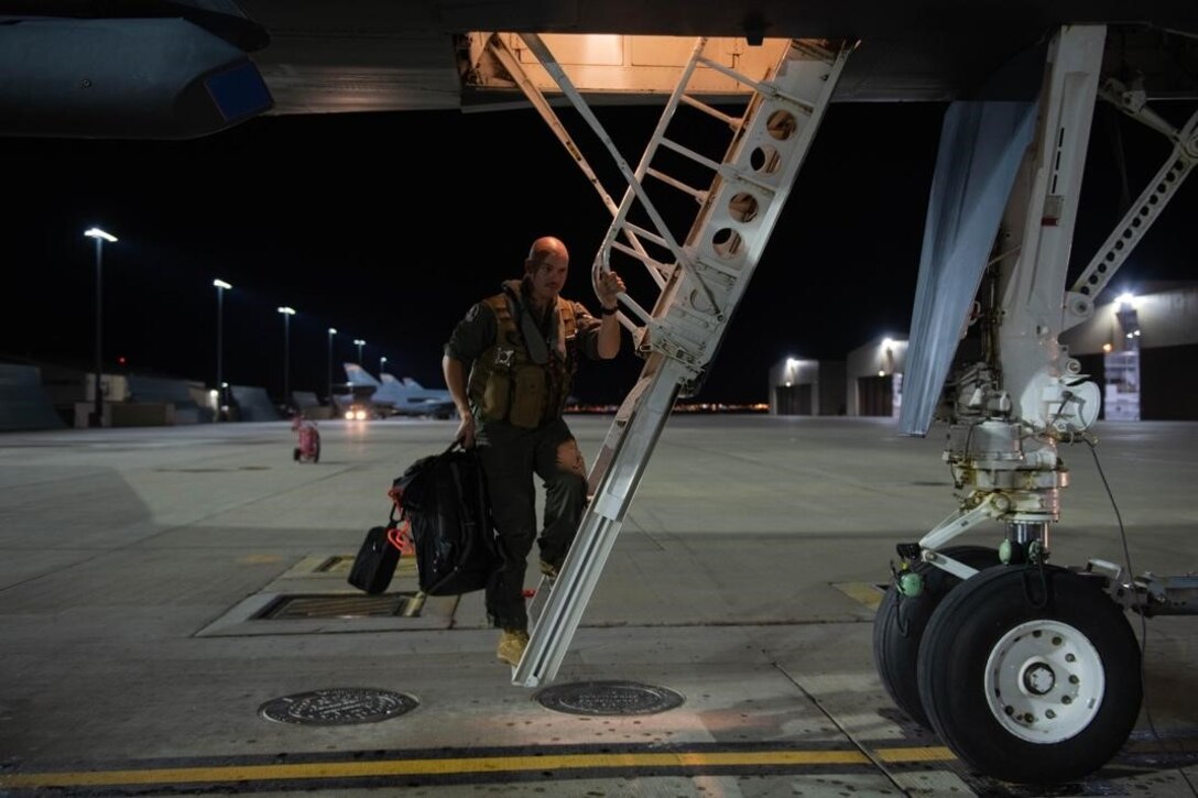 An aviator from the 34th Bomb Squadron steps down from a B-1B Lancer after returning from a Bomber Task Force (BTF) mission at Ellsworth Air Force Base, S.D., Sept. 8, 2021.