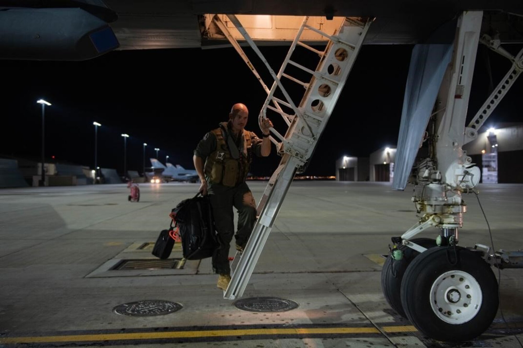 An aviator from the 34th Bomb Squadron steps down from a B-1B Lancer after returning from a Bomber Task Force (BTF) mission at Ellsworth Air Force Base, S.D., Sept. 8, 2021.