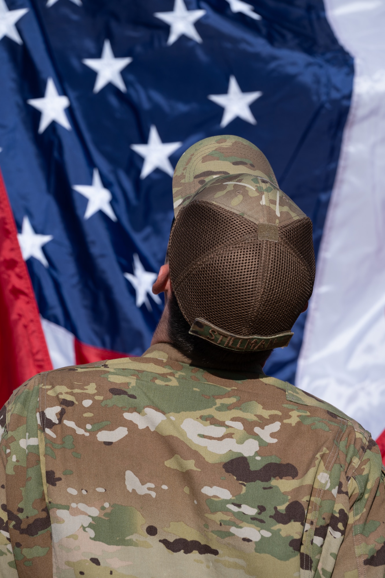 Airman looking up at the American flag