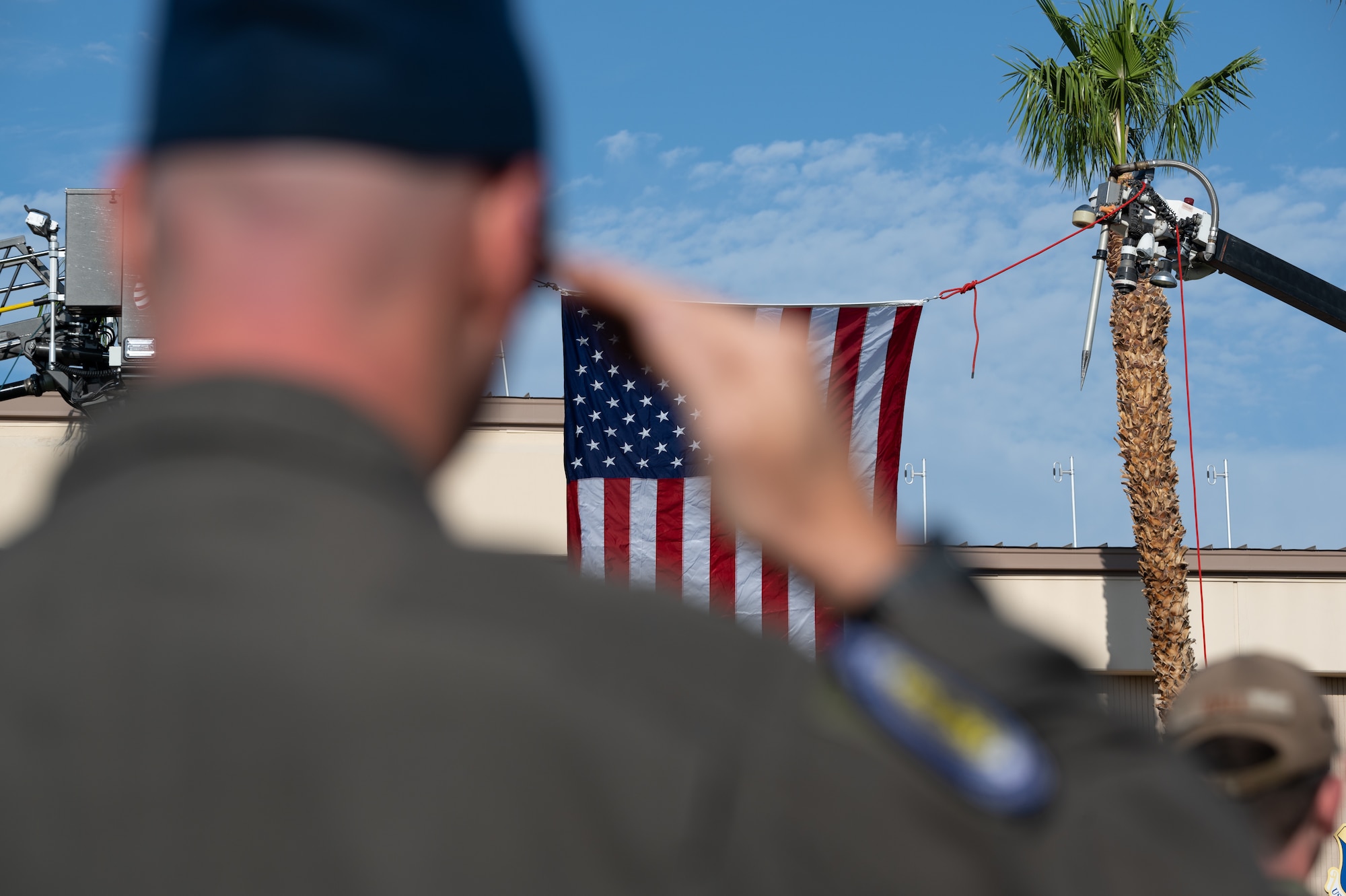 Airman saluting the American flag