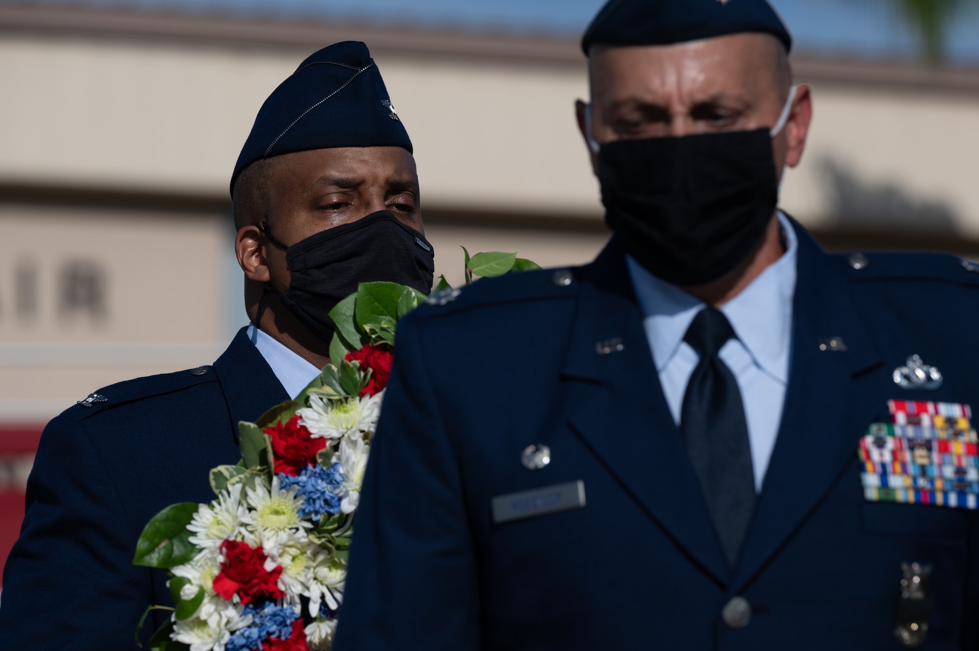 Airmen walking with a wreath