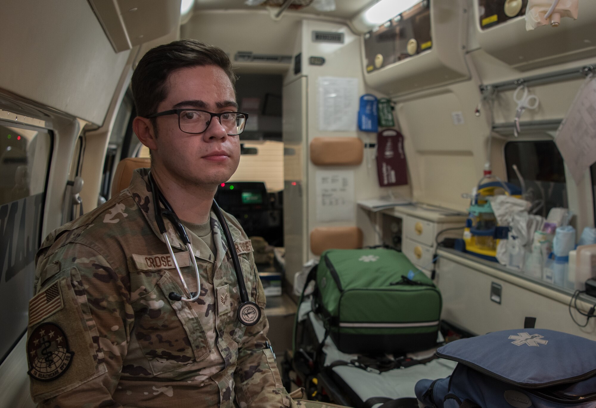 An Airman sitting in the back of an Ambulance.