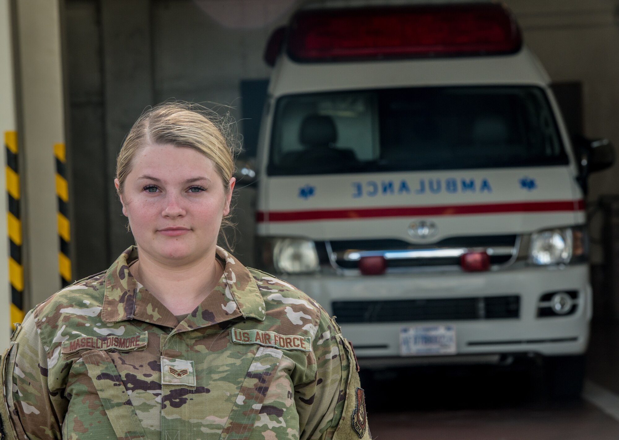 An Airman standing in front of an ambulance.