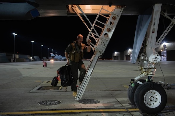 An aviator from the 34th Bomb Squadron steps down from a B-1B Lancer after returning from a Bomber Task Force (BTF) mission at Ellsworth Air Force Base, S.D., Sept. 8, 2021.