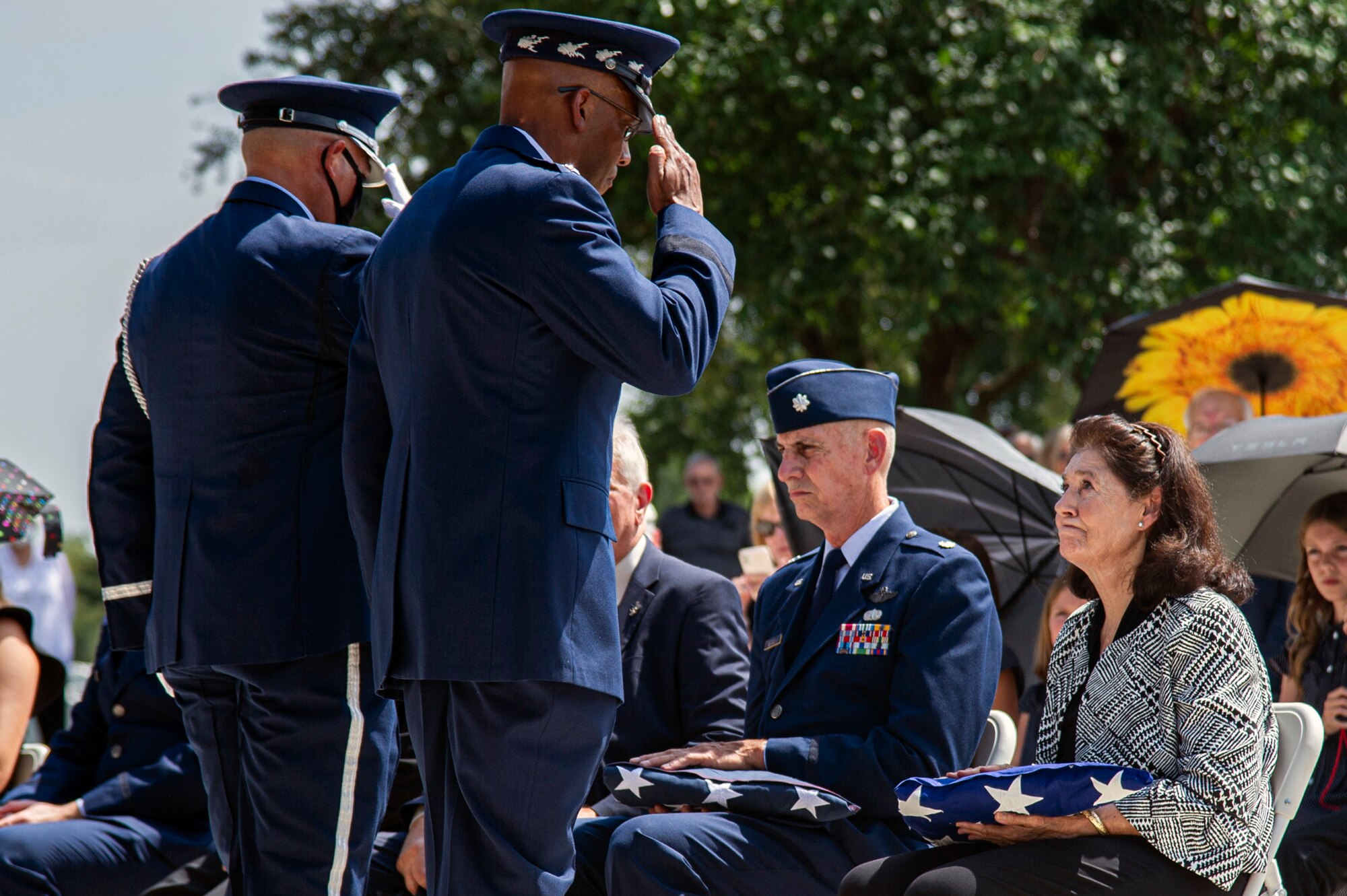 Air Force Chief of Staff Gen. CQ Brown Jr. presents the U.S. flag to retired Col. Richard E. Cole’s daughter, Cindy Chal, during his interment ceremony, Sept. 7, 2021.