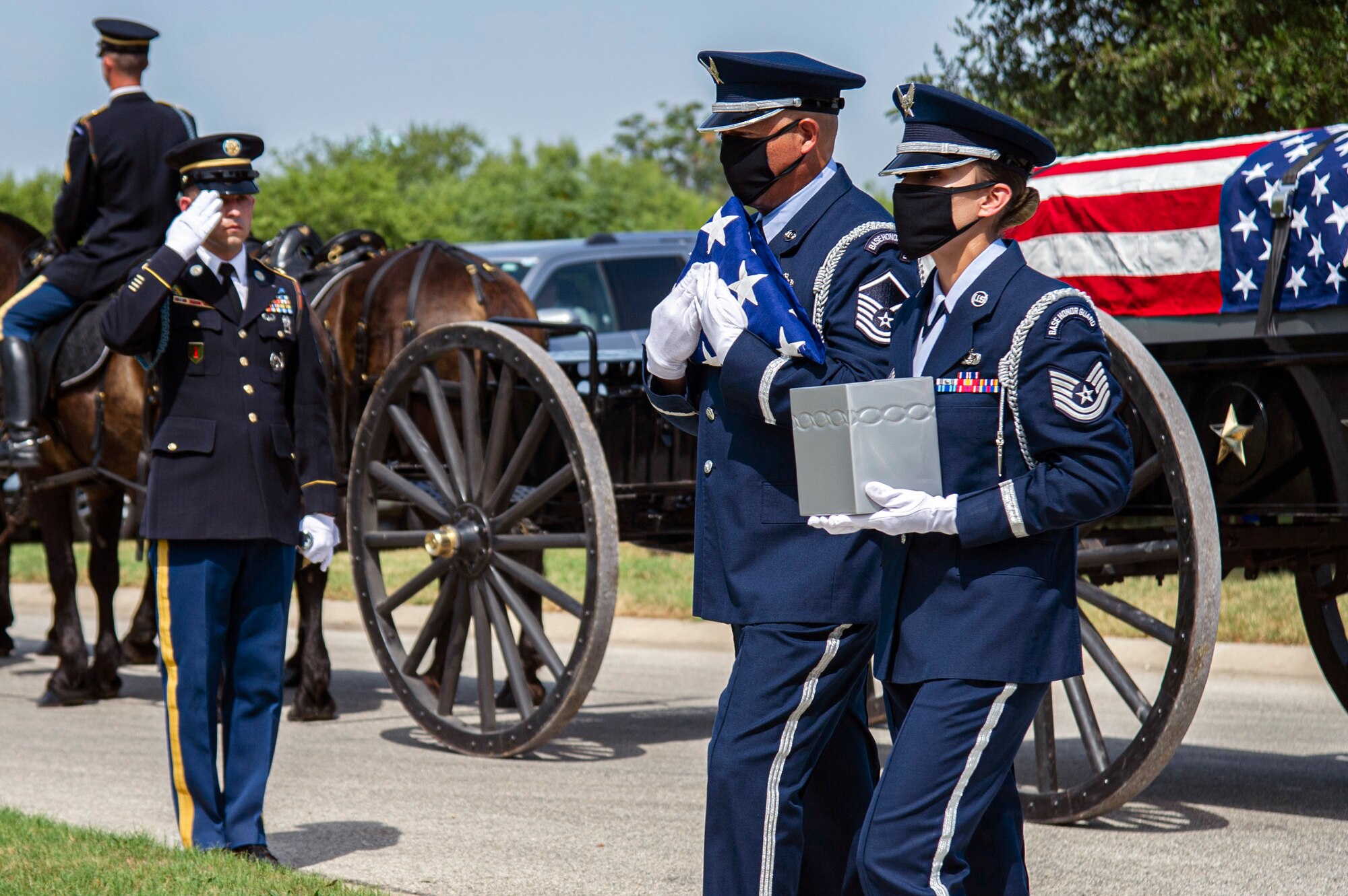 Air Force Honor Guard members carry the remains of retired Col. Richard E. Cole  and the U.S. flag during his interment, Sept. 7, 2021.