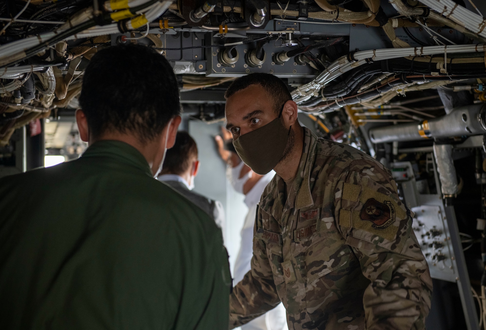 A flight engineer assigned 21st Special Operations Squadron gives a tour of a CV-22 Osprey