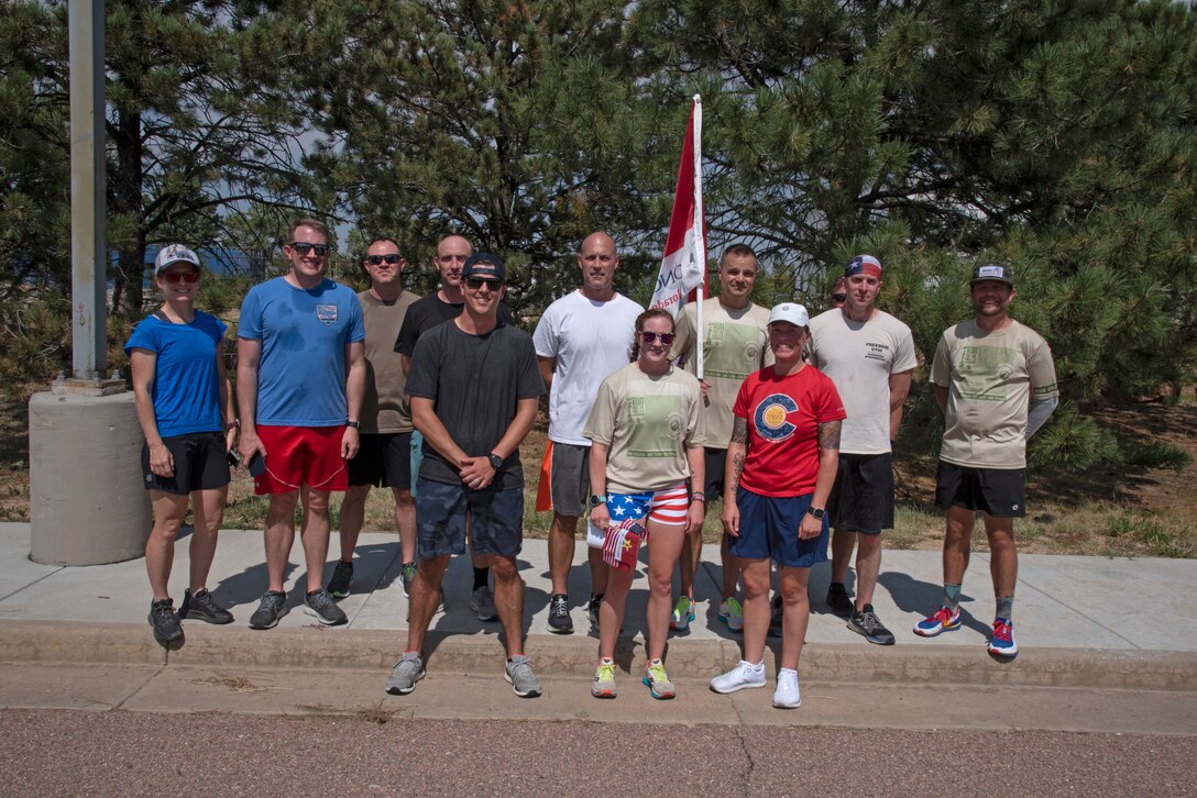 Runners pose for photo following fallen service member run