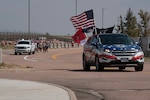 Police escort runners during event honoring fallen service members