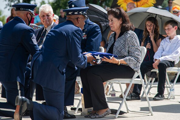 Air Force Honor Guard members fold the U.S. flag during the interment of retired Col. Richard E. Cole.