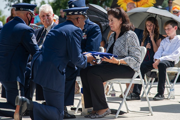 Air Force Honor Guard members fold the U.S. flag during the interment of retired Col. Richard E. Cole.