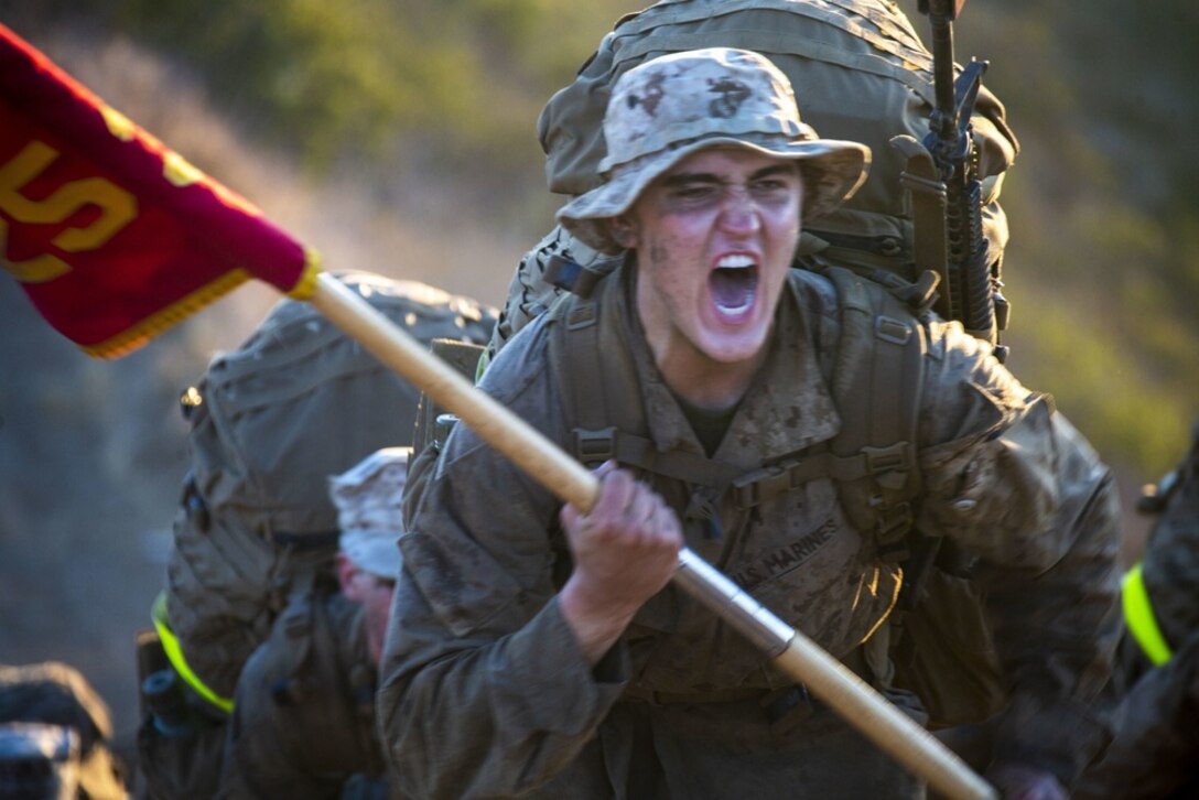 A U.S. Marine Corps recruit with Lima Company, 3rd Recruit Training Battalion, charges a hill during the final hike of the crucible at Marine Corps Base Camp Pendleton, California, July 29, 2021. The crucible is a 54-hour long culminating event at recruit training which will finalize the transformation from recruit to Marine. Educators were afforded the opportunity to witness this ceremony during the Educator's workshop. The Educator's Workshop is a five-day program designed to better inform educators and influential figures about the benefits and opportunities available during service in the Marine Corps. This allows participants to return home and provide firsthand experience and knowledge to individuals interested in military service. (U.S. Marine Corps photo by Staff Sgt. Kelsey Dornfeld)