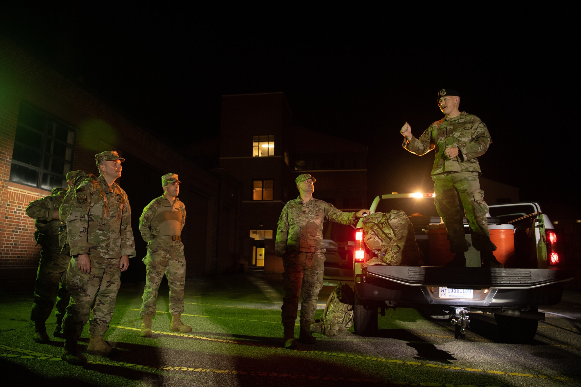 A group of Airmen walk and run outside in an event.