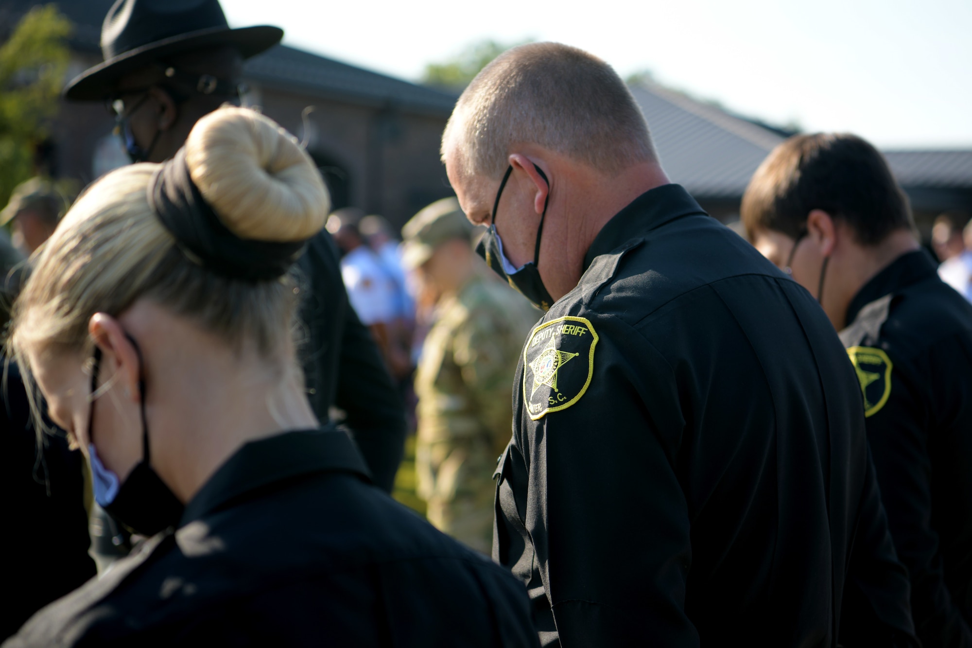 Members of the Sumter County Sheriff’s Department bow their heads for prayer during a 9/11 memorial ceremony in Sumter, S.C., Sept. 11, 2021. The ceremony was held in remembrance of the 20th anniversary of the Sept. 11, 2001, attacks across the United States. (U.S. Air Force photo by Staff Sgt. K. Tucker Owen)
