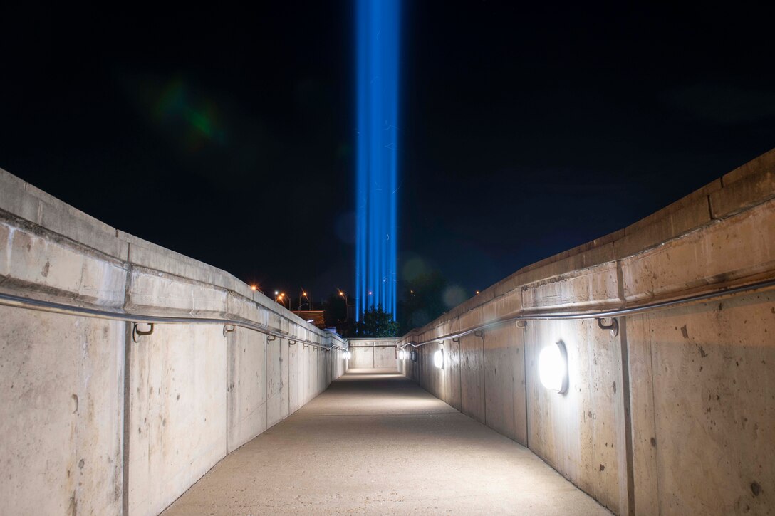 A stream of multiple blue lights shoot skyward.