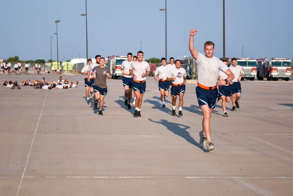 312th Training Squadron students run a two-mile obstacle course during the Blood, Sweat, and Stairs event at the Louis F. Garland Department of Defense Fire Academy on Goodfellow Air Force Base, Texas, Sept. 11, 2021. The event featured a memorial physical training course to remember the firefighters and first responders who risked their lives on 9/11. (U.S. Air Force photo by Senior Airman Jermaine Ayers)