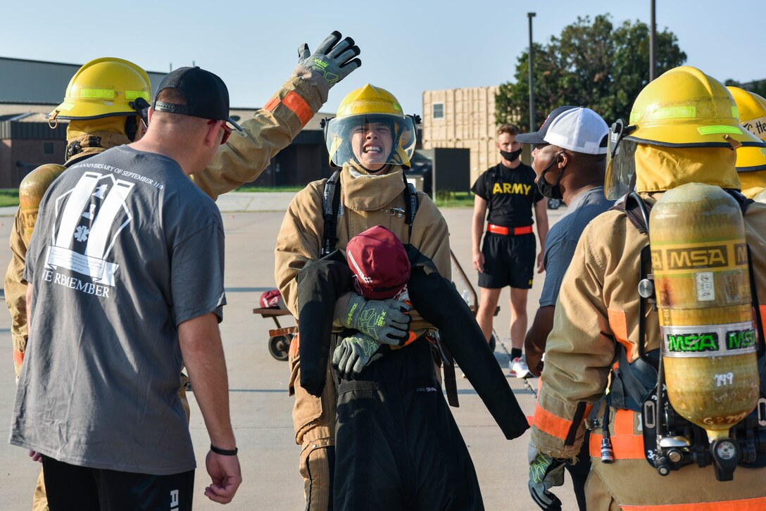 A 312th Training Squadron student drags a 185-pound dummy during the Blood, Sweat, and Stairs event at the Louis F. Garland Department of Defense Fire Academy on Goodfellow Air Force Base, Texas, Sept. 11, 2021. 10 student teams participated in multiple activities during this firefighter-oriented obstacle course. (U.S. Air Force photo by Senior Airman Jermaine Ayers)