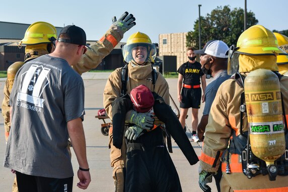 A 312th Training Squadron student drags a 185-pound dummy during the Blood, Sweat, and Stairs event at the Louis F. Garland Department of Defense Fire Academy on Goodfellow Air Force Base, Texas, Sept. 11, 2021. 10 student teams participated in multiple activities during this firefighter-oriented obstacle course. (U.S. Air Force photo by Senior Airman Jermaine Ayers)