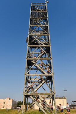 312th Training Squadron students run up the High Angle Rescue Tower during the Blood, Sweat, and Stairs event at the Louis F. Garland Department of Defense Fire Academy on Goodfellow Air Force Base, Texas, Sept. 11, 2021. Students ran up and down this tower to commemorate the firefighters and first responders who entered the world trade center towers to save people during the attack on 9/11. (U.S. Air Force photo by Senior Airman Jermaine Ayers)