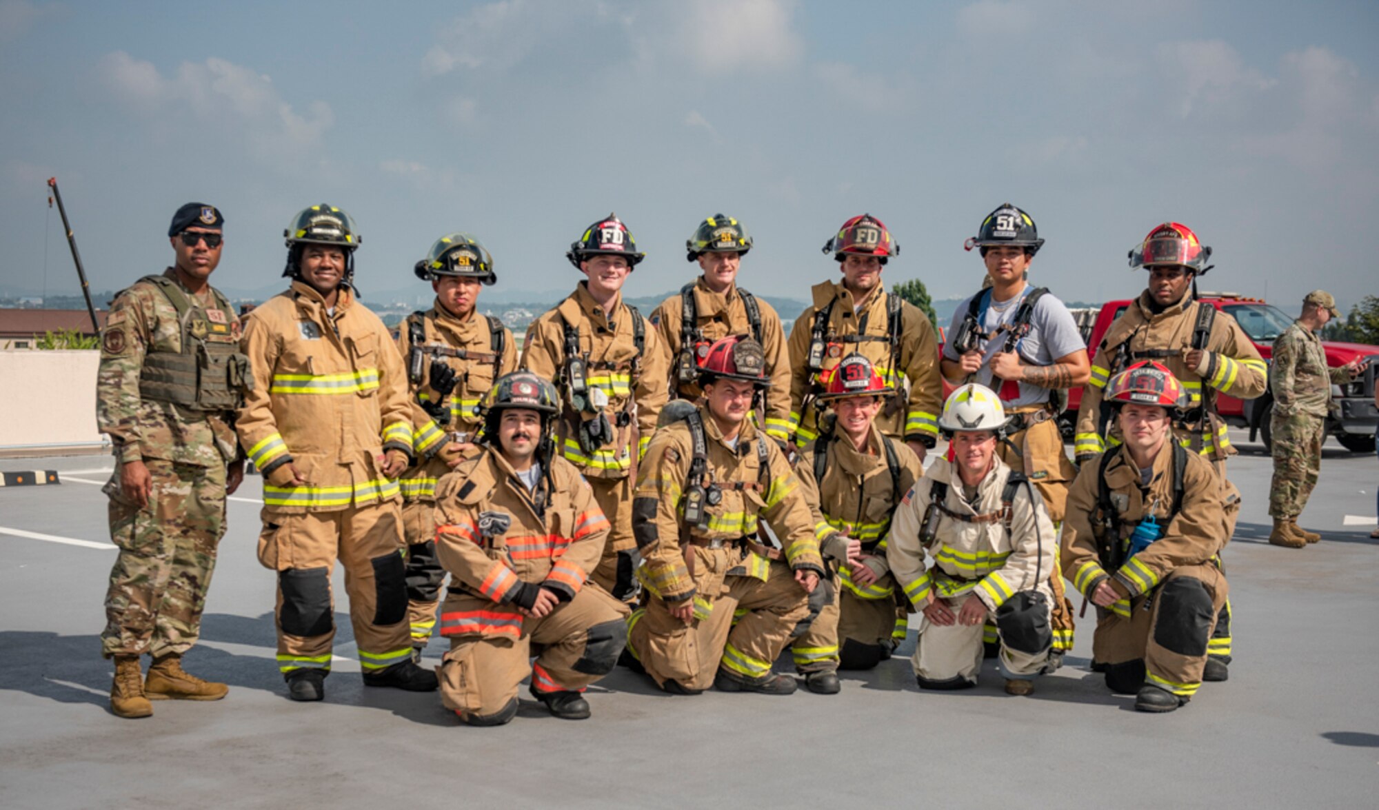 Col. Joshua Wood, 51st Fighter Wing commander, stands with fire fighters assigned to the 51st Civil Engineer Squadron before climbing 110 flights of stairs during a 20th Anniversary 9/11 Remembrance Ceremony at Osan Air Base, Republic of Korea, Sept. 11, 2021